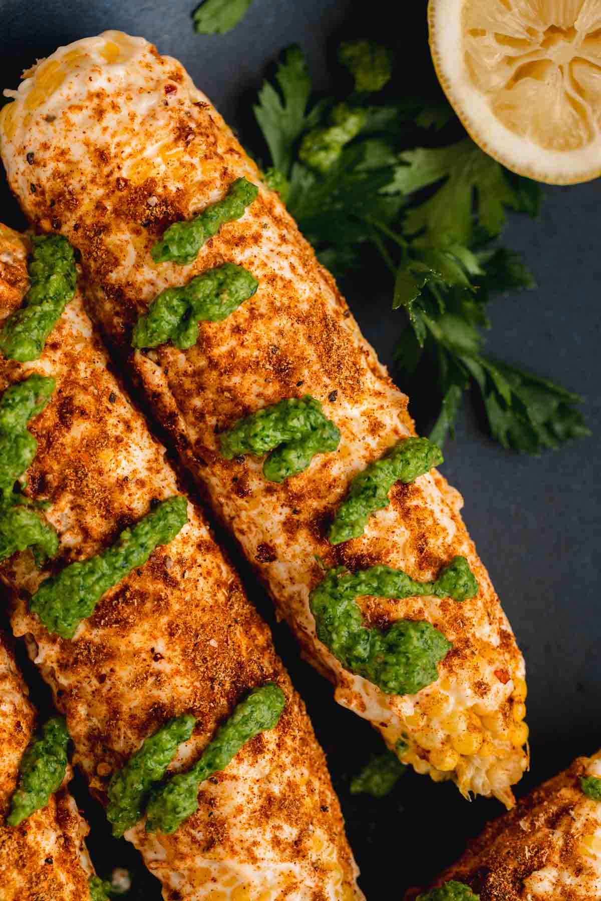 Shawarma Corn on the Cob topped with garlic mayo, shawarma seasoning and schug sauce. 