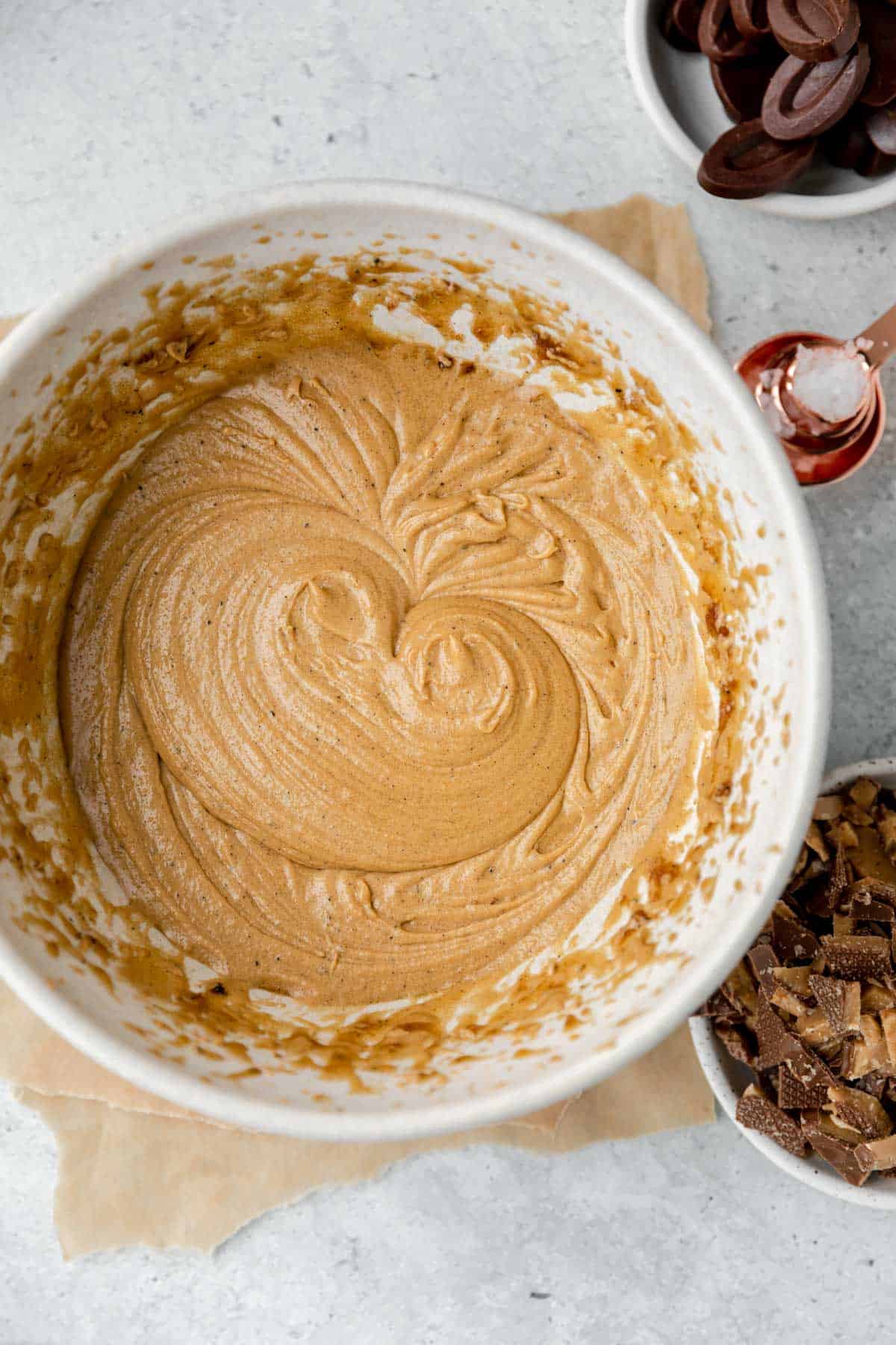 Butter and sugar creamed together with eggs and vanilla added in a bowl.