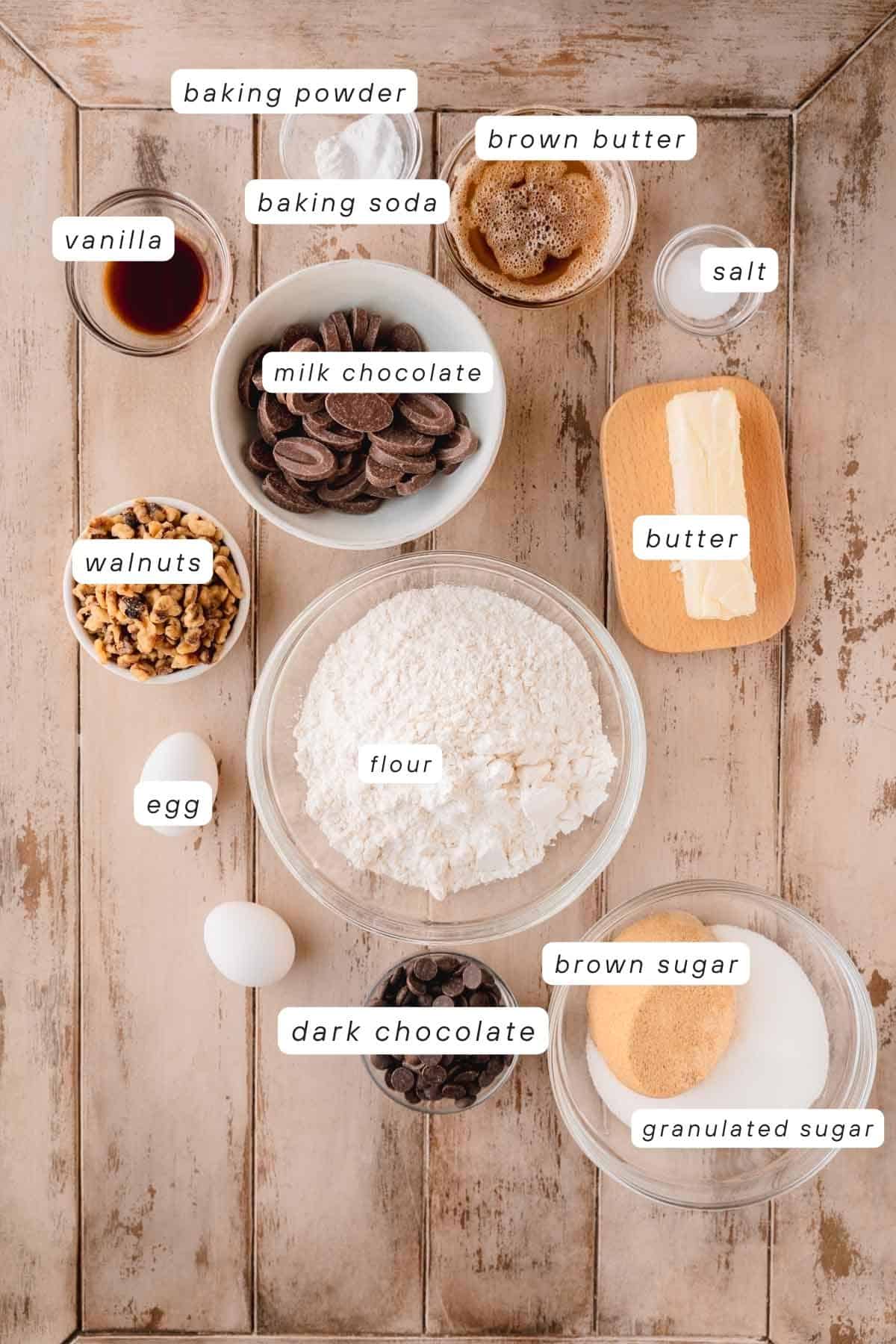 Brown butter, baking powder, baking soda, salt, butter, flour, brown sugar, granulated sugar, milk chocolate, dark chocolate, eggs, walnuts and vanilla extract. 