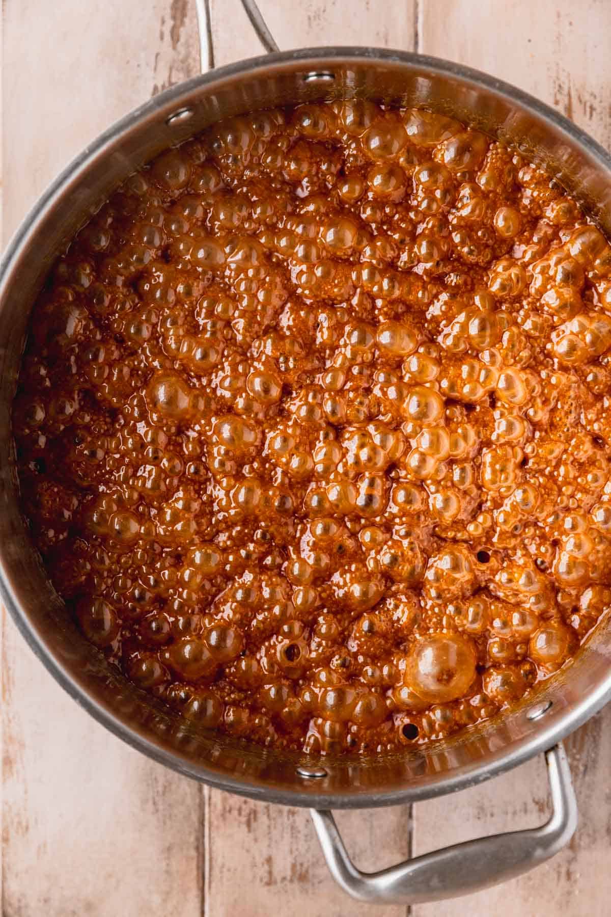 Caramel sauce in the pan after heavy cream has been added and whisked.