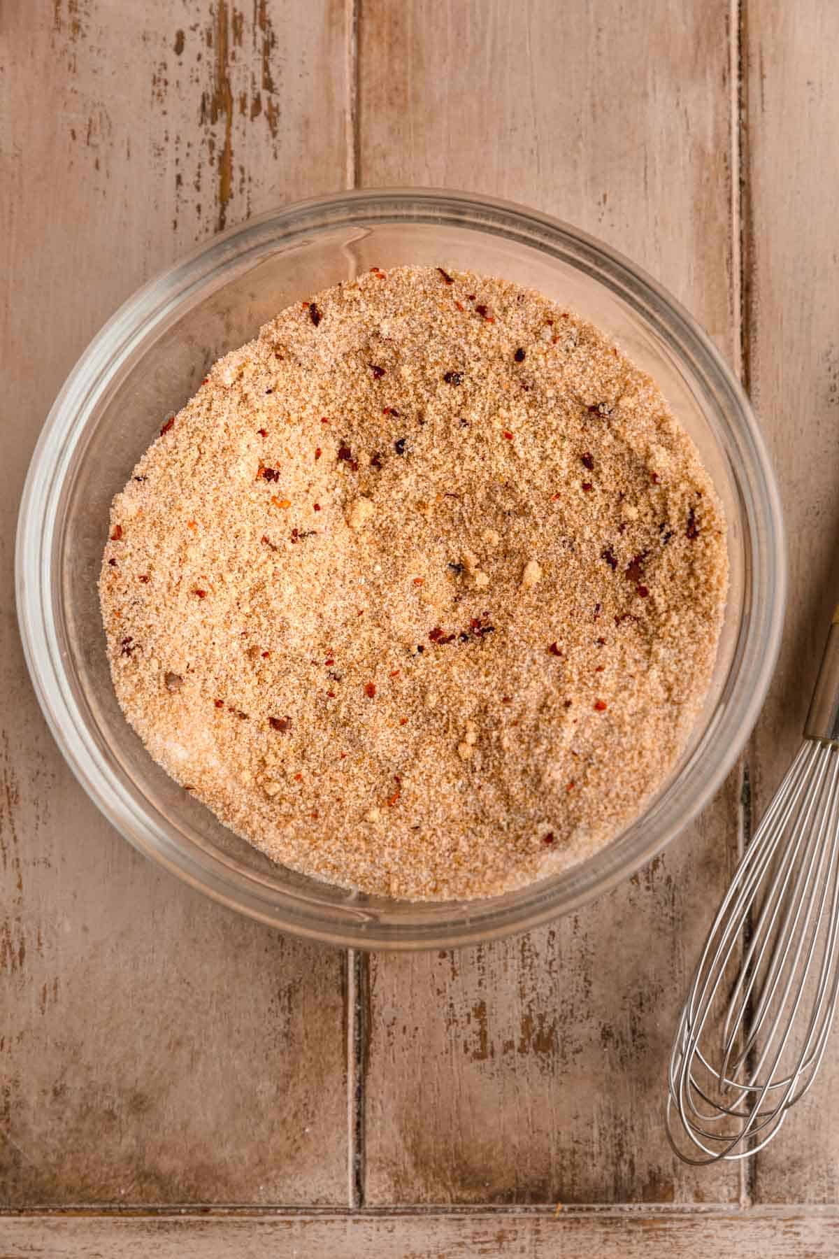 Spice mixture in a bowl including cinnamon, sugar, nutmeg and Aleppo pepper. 