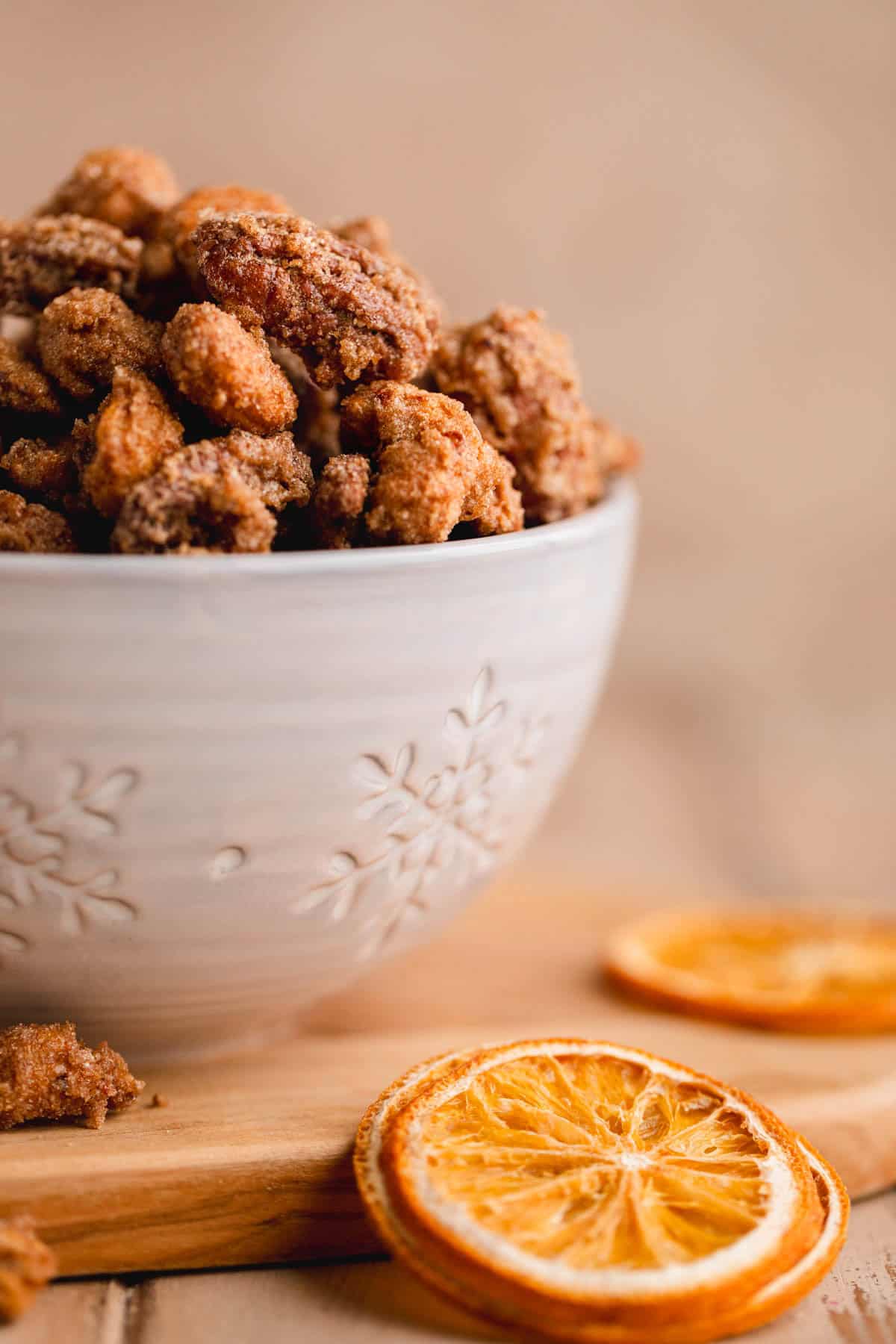 Holiday Candied Nuts in a dish featuring cashews and pecans with cinnamon, nutmeg and sugar.