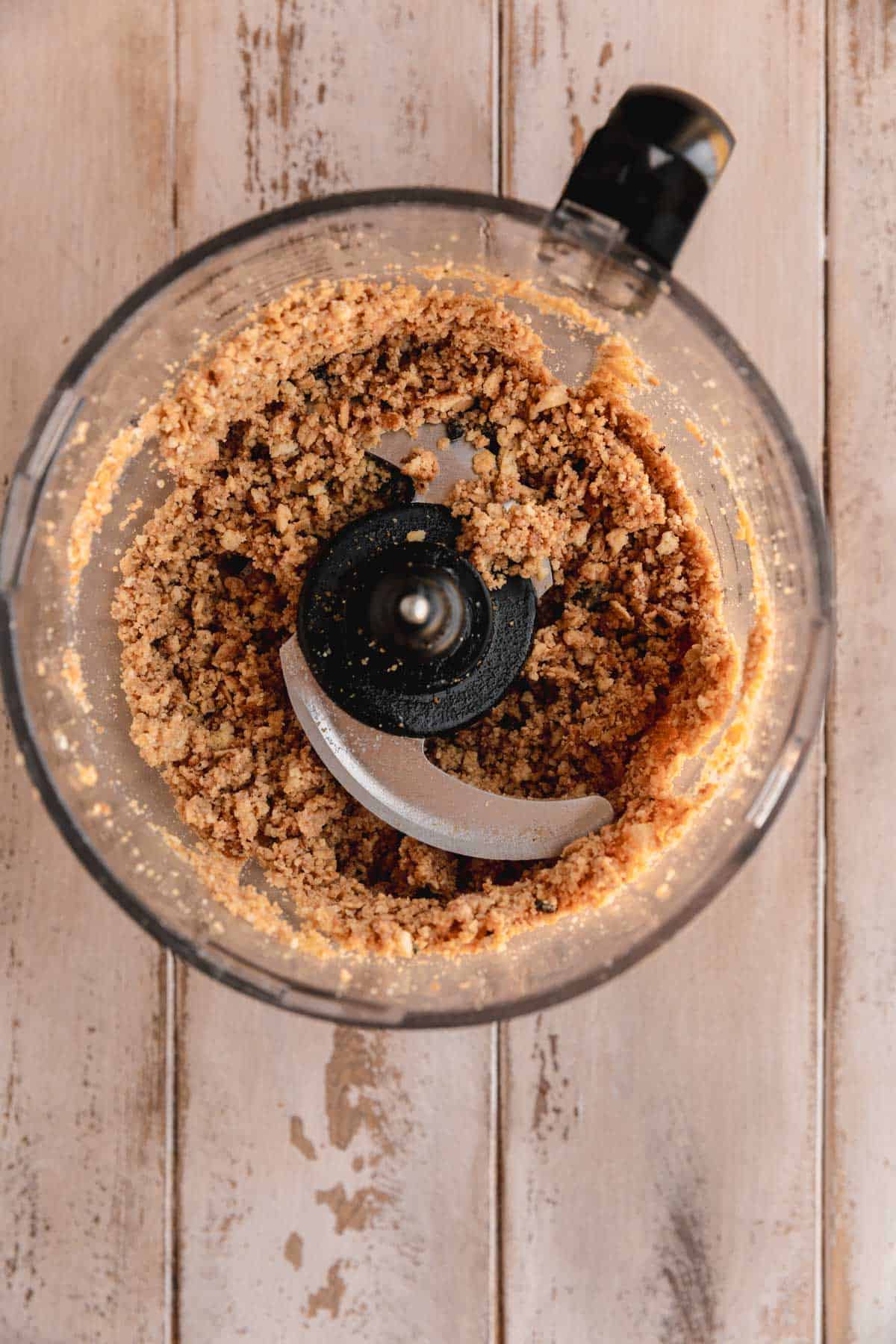 Blended cookies and lemon granola in a food processor.