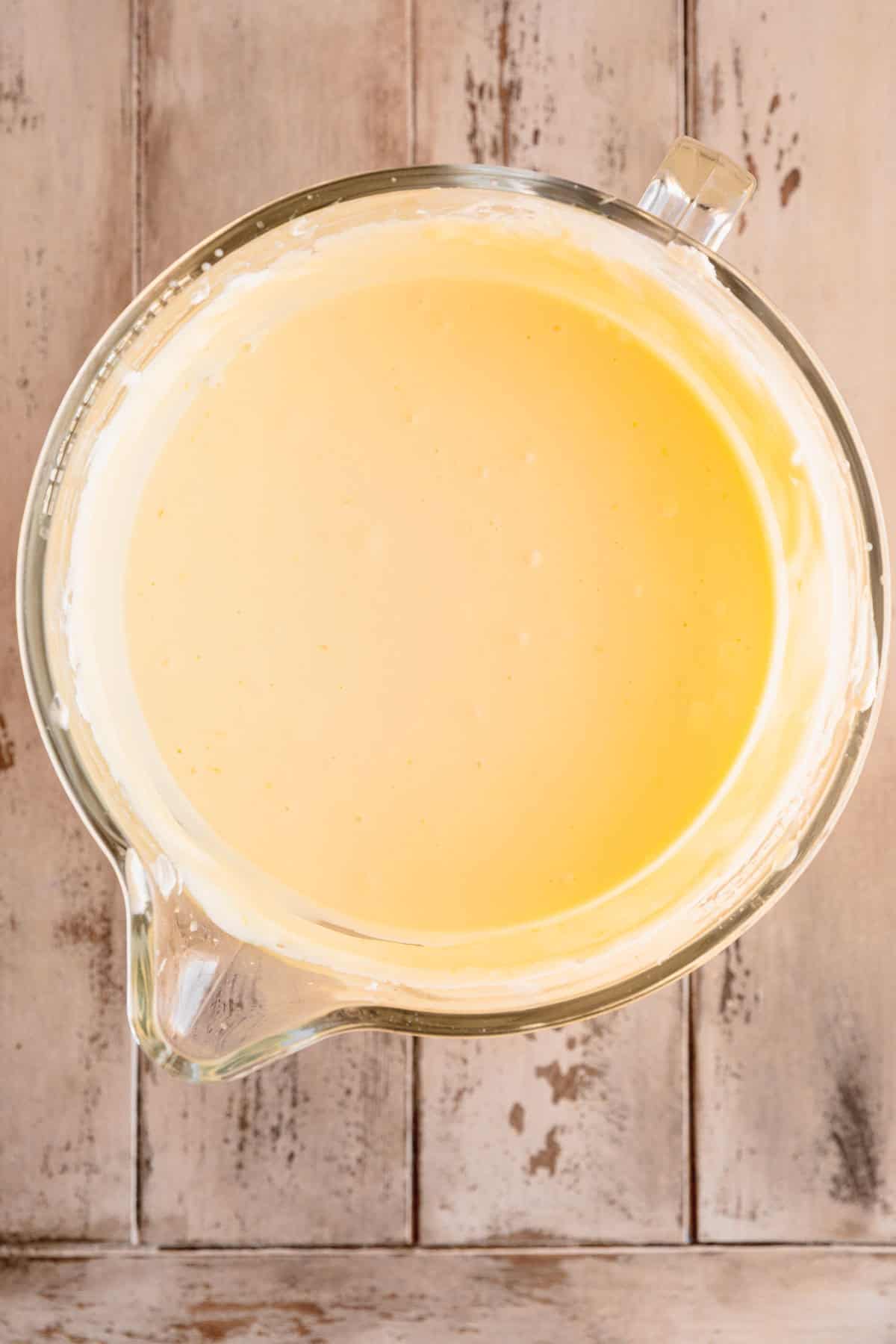 Lemon cheesecake batter in the bowl of a stand mixer. 