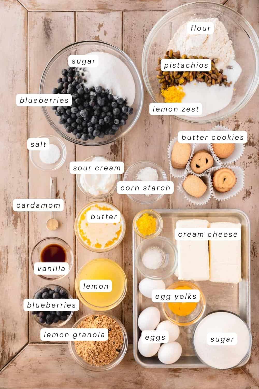 Granulated sugar, blueberries, flour, pistachios, lemon zest, salt, butter cookies, cream cheese, eggs, egg yolk, lemon granola, lemon juice, vanilla, butter, cardamom, corn starch and sour cream.