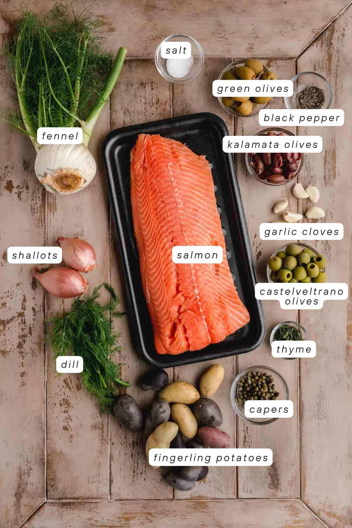 Salmon, salt, pepper, green olives, kalamata olives, garlic cloves, castelvetrano olives, thyme, capers, fingerling potatoes, dill, shallots, and fennel.