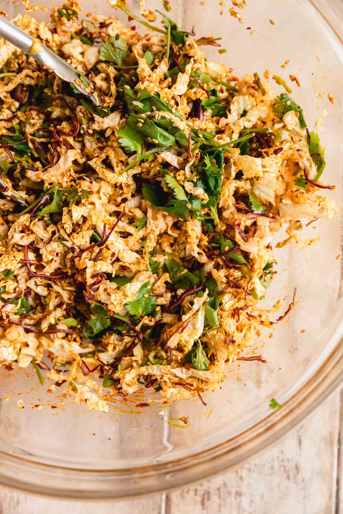 Chili oil slaw mixed up in a bowl.