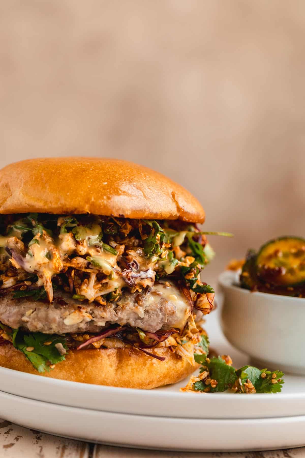 Pork Dumpling Burger on a brioche bun with chili crisp slaw and sweet kewpie mayo.