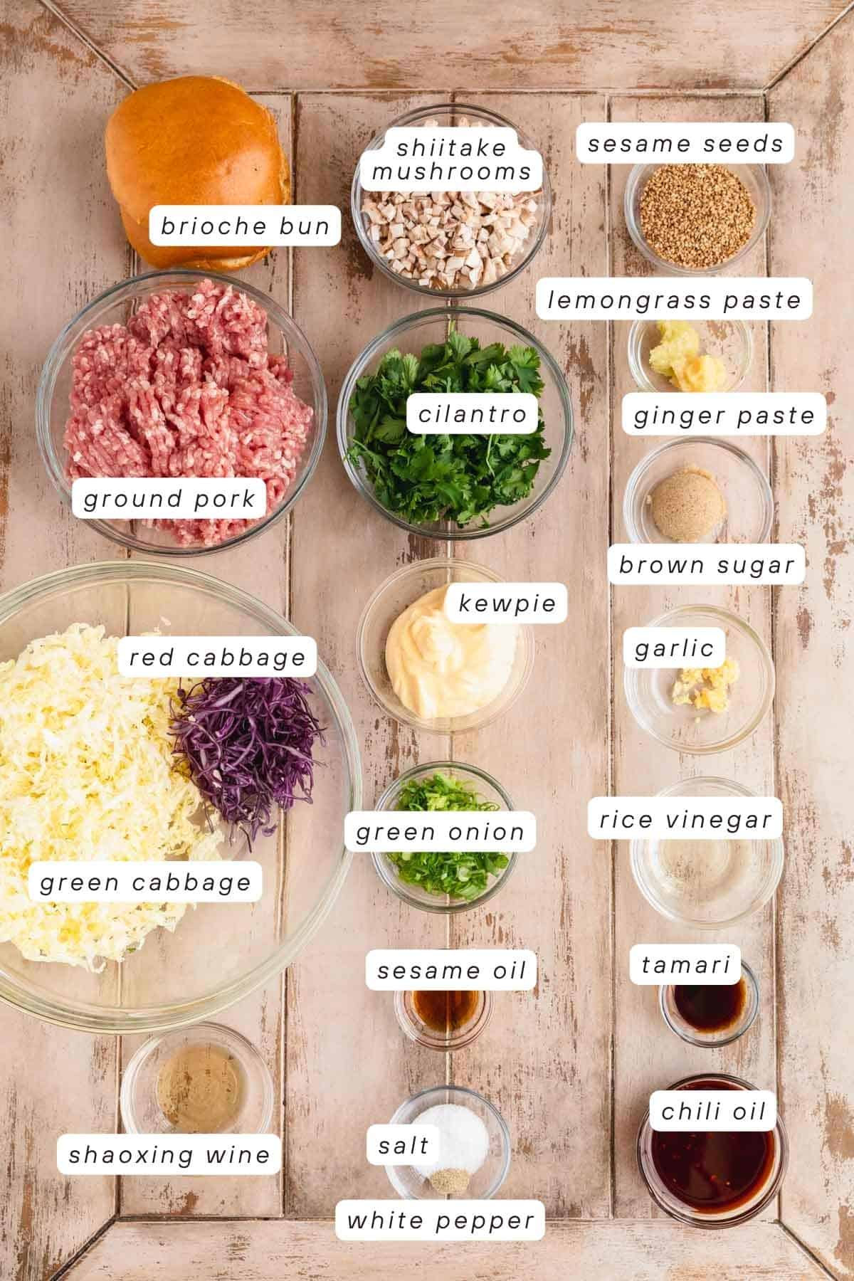 Brioche bun, shiitake mushrooms, sesame seeds, ginger paste, lemongrass, brown sugar, ginger, rice vinegar, tamari, chili oil, salt, white pepper, sesame oil, green onions, Kewpie mayo, shaoxing wine, green and purple cabbage and ground pork.