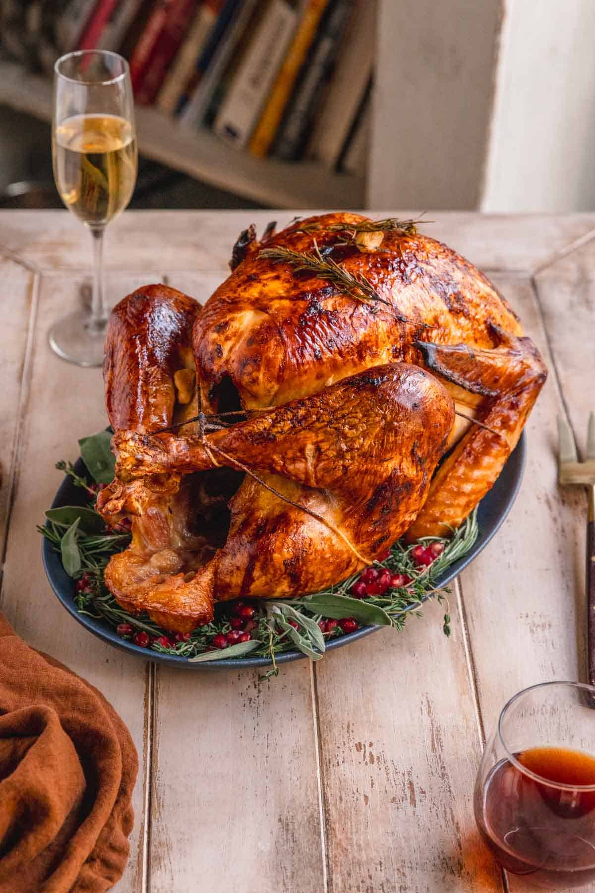 Thanksgiving turkey with champagne and herbs on the table.