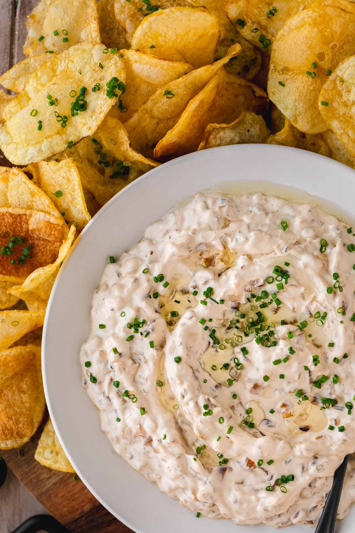 Caramelized Onion Dip in a bowl surrounded by chips.