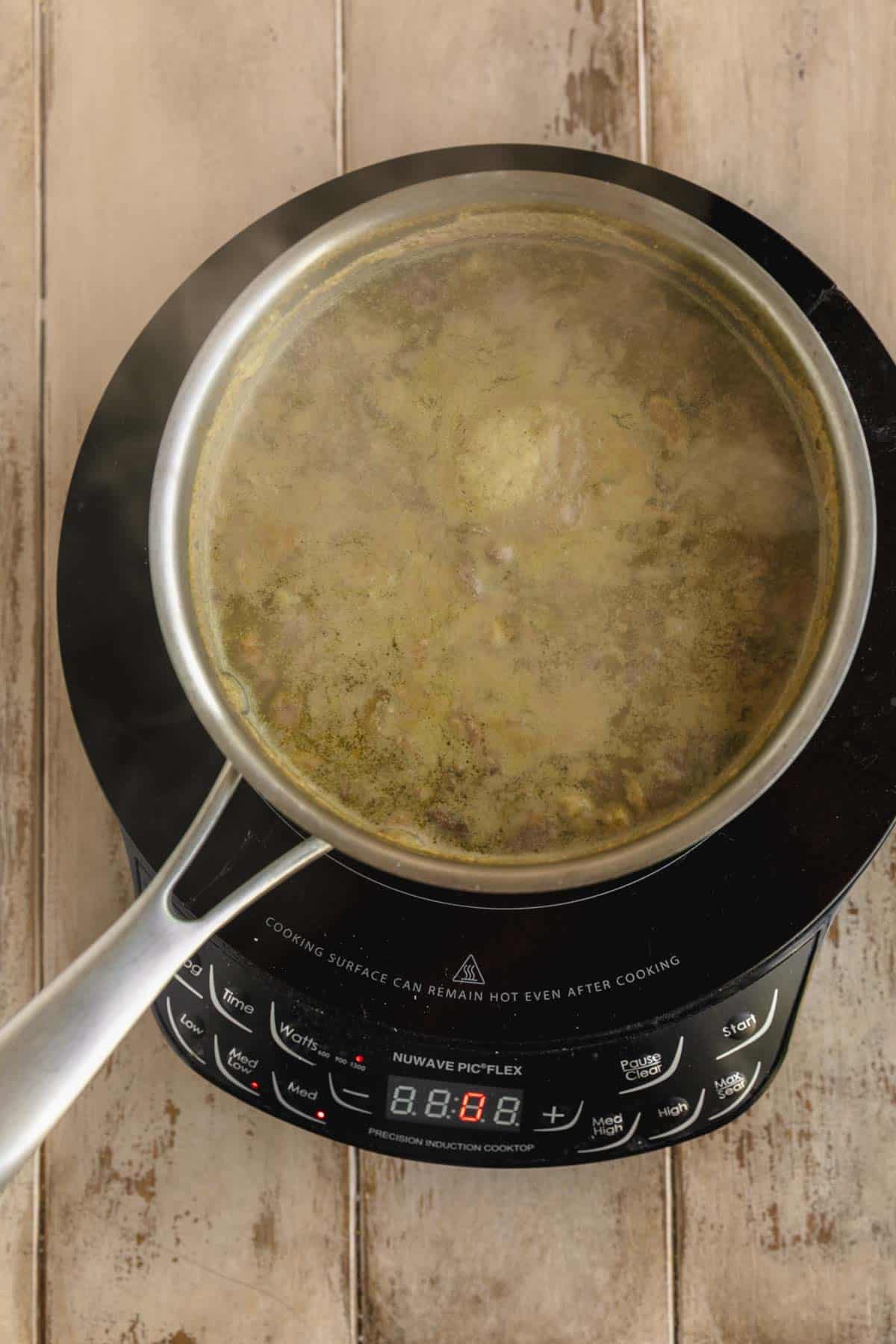 Pistachios boiling in a pot of water.